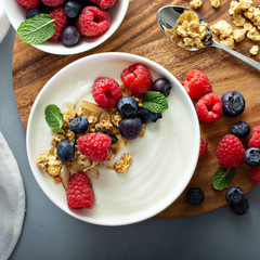 Plain yougurt with granola and berries on side, fresh, healthy and colorful breakfast