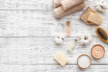 Spa set with eco materials for organic treatment on white wooden background top view space for text