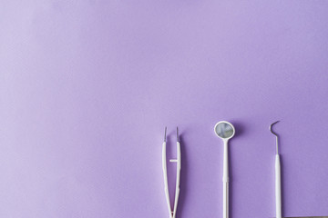 Dental instruments on colorful background with copy spac. Top view.