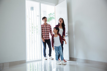 family asian entering their new home. buying new house concept