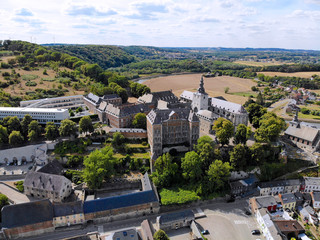 Fototapeta na wymiar Aerial view of Floreffe Abbey during summer day, Belgium. Old abbey where they produced famous Floreffe beer. Top view green valley with beautiful abbey.