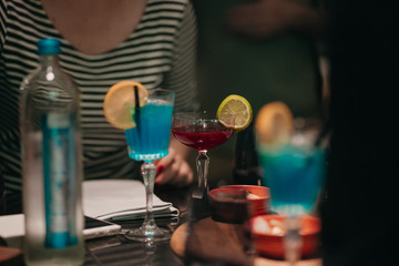 Friends having cocktails in bar at night