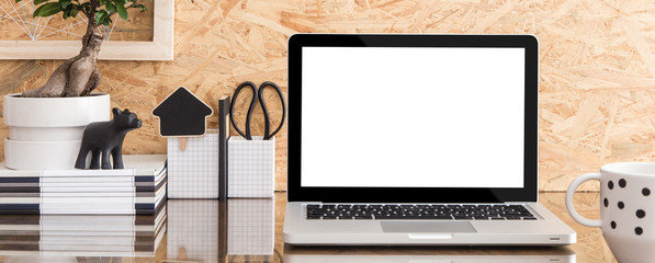 Stylish workspace with laptop mockup and coffee mug. Panoramic, banner style image.