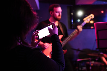Person taking a picture at a concert