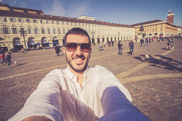 happy man tourist taking selfie photo in Turin Torino city, Piedmont, italy