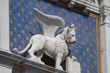 St Mark's Clock tower on Piazza San Marco, Lion of Saint Mark relief on facade, Venice, Italy.2019