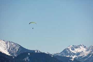 Fototapeta na wymiar Paraglider flying over Bregenzerwald forest