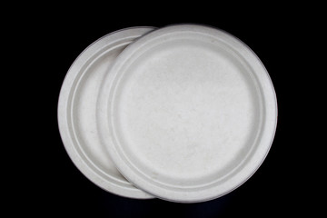 White Empty paper dishes, Natural plant fiber food plate, Paper plate isolated on black background.