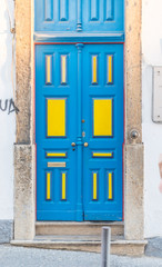 Yellow and blue door on an old house.