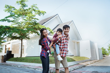 father piggyback ride with his son in front of the house playing enjoying their time in the morning