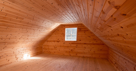 A room with wooden paneling and a small window