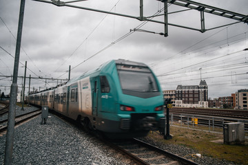 Fototapeta na wymiar Blurred train motion with high speed at railway station
