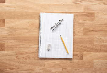 Pencil and paper on a wooden table