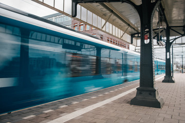 Blurred train motion with high speed at railway station