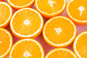 Background of oranges fruits. Many halves of fresh oranges, top view. Citrus for making juice. A lot of sliced oranges on white background. Concept