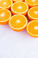 Background of oranges fruits. Many halves of fresh oranges, top view. Citrus for making juice. A lot of sliced oranges on white background. Concept