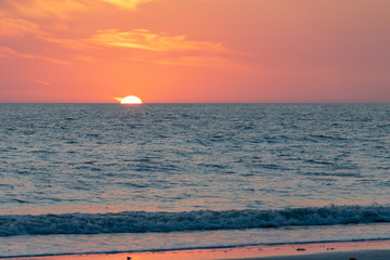 Beach at dawn with a pink sky