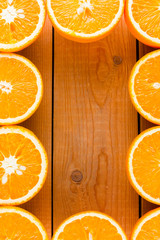 Oranges fruit on wooden boards. Halves of juicy orange on wooden background. Orange fruit, citrus minimal concept. Top view, copy space