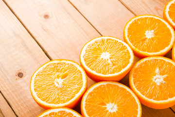 Oranges fruit on wooden boards. Halves of juicy orange on wooden background. Orange fruit, citrus minimal concept. Top view, copy space