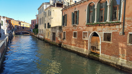 Fototapeta na wymiar Classical picture of venetian canals with boats across canal. Venice, Italy ,march , 2019