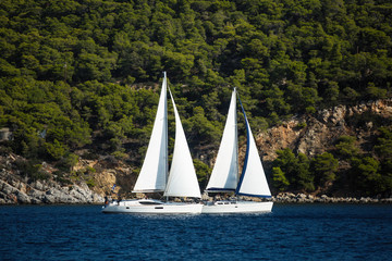 Fototapeta premium Sailing luxury boats participate in sail yacht regatta in the Aegean Sea - Greece.