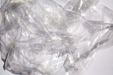 Abstract crumpled transparent plastic bag texture on white background, Close up & Macro shot, Selective focus, Light & Shadow, Recycle concept