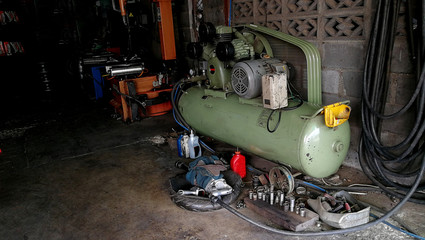 Air pump in car tire repair garage 