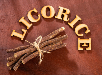 Close up of Ayurvedic herb Liquorice root,Licorice root, Mulethi or Glycyrrhiza glabra root on a wooden surface is very much beneficial for Soothes your stomach,poisoning, stomach ulcers
