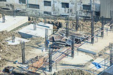 Construction Industry, Concrete building construction site. Concrete piles driven into the substructure ground at foundation pit. Industrial Business, Working Place, Work and Labor, Economy concept.