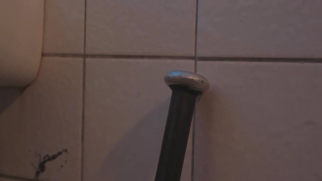 baseball bat female hand takes baseball bat in old bathroom sink nah near
