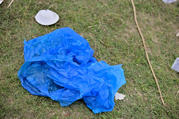 Waste Plastic packets are dumped on dirty soil ground