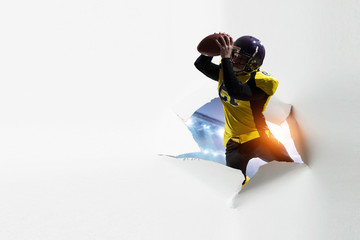Paper breakthrough hole effect and football player. Mixed media