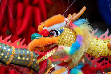 Colourful traditional souvenirs in china market, Chinatown, Singapore. Chinese dragon close up. Chinese New Year decoration