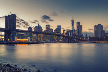 Naklejka na ściany i meble Brooklyn bridge East river and Manhattan after sunset, New York City