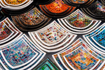 Colorful mosaic decorative plates on the market for sale on street market in Ubud, island Bali, Indonesia, closeup . Souvenirs for tourist