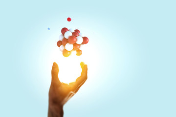 Man s hand and cubes levitating above. Mixed media