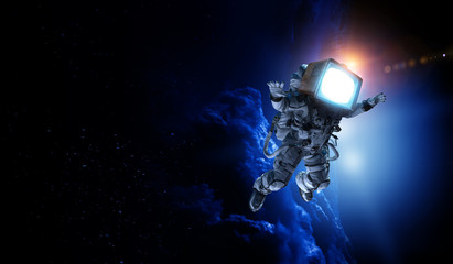 Obraz na płótnie Canvas Astronaut with TV head in space. Mixed media.