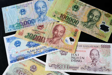 Vietnamese dong bills on a dark background close up. Money background
