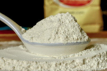 wheat flour in a spoon whole flour all purpose flour, close up
