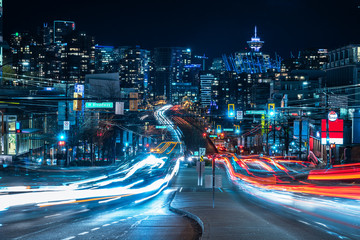 light trails go out of the downtown vancouver - obrazy, fototapety, plakaty