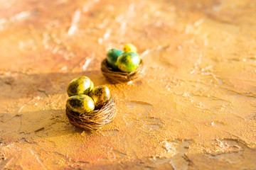 Composition with Easter eggs in nest, on orange background. Easter Egg with copy space for text.Happy Easter greeting card. an invitation to celebrate easter sunday.Easter minimal concept