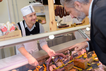 customer buying pate in a deli shop