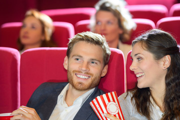 happy young couple having a date at the cinema
