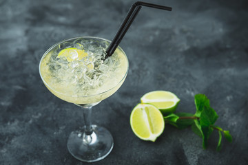 Mojito cocktail in glass and lime fruit on a table. Summer drink