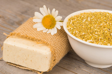 homemade organic soap with chamomile flowers and dry ingredients