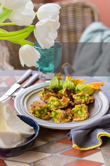 Pumpkin flowers fried in batter. Traditional italian dish. Home dinner and flowers.