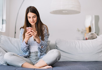 Girl at home listening music. Beautiful young woman listening to music indoors.