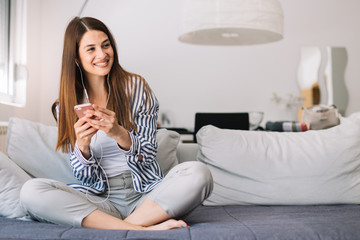 Girl at home listening music. Beautiful young woman listening to music indoors.