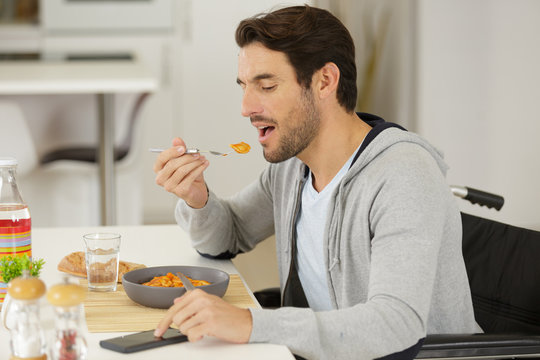 Cheerful Disabled Man Having Lunch