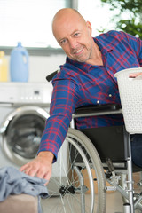 disabled man on wheelchair doing laundry